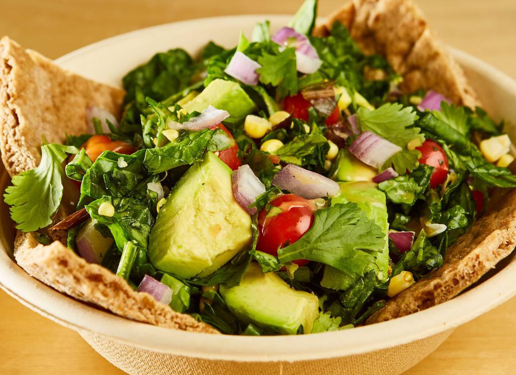 Avocadito Salad · Chopped organic baby spinach, avocado hass, raw corn, cilantro, radish, cherry tomatoes, onions, avocado vinaigrette and a warm pita bread.