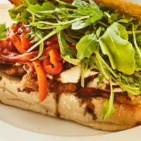 The Godmother · Chicken milanese with fresh mozzarella, arugula, roasted red peppers and balsamic glaze on s...