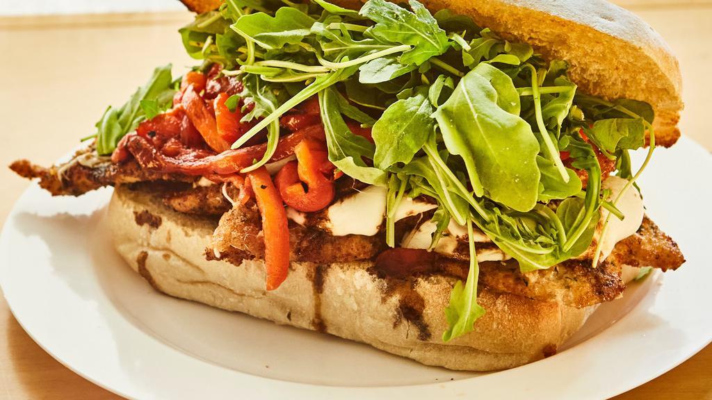 The Godmother · Chicken milanese with fresh mozzarella, arugula, roasted red peppers and balsamic glaze on streci doppio hero.