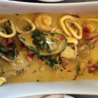 Pescado A Lo Macho · Fish and seafood with sauce.
