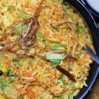 Chicken Biryani · Layers of basmati rice cooked traditionally with herbs and spices.