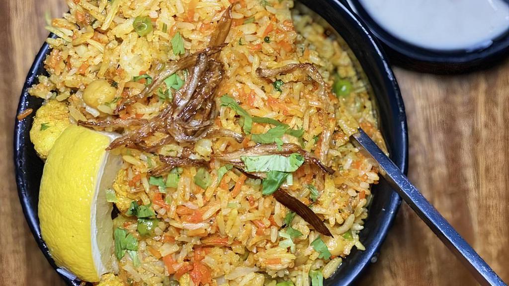 Chicken Biryani · Layers of basmati rice cooked traditionally with herbs and spices.