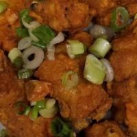 Spicy Chicken Wings · Cut up chicken wings refried with scallions and peppers