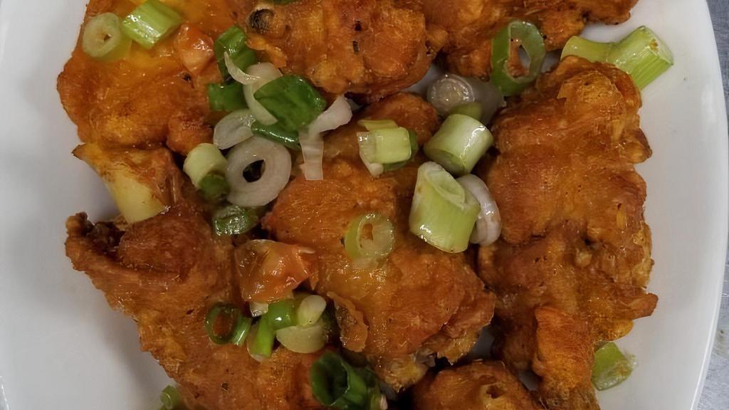 Spicy Chicken Wings · Cut up chicken wings refried with scallions and peppers