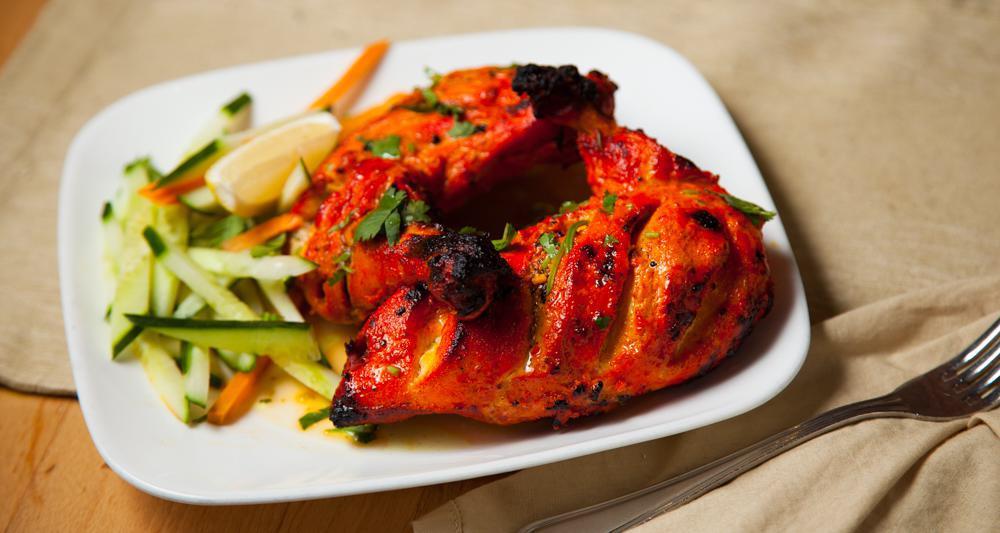 Tandoori Chicken · Gluten free. An all time favorite preparation; chicken on the bone in a marinade of ginger & garlic paste, strained yogurt, Kashmiri red chillies (mostly used for the crimson red color) and tellicherry peppercorns.