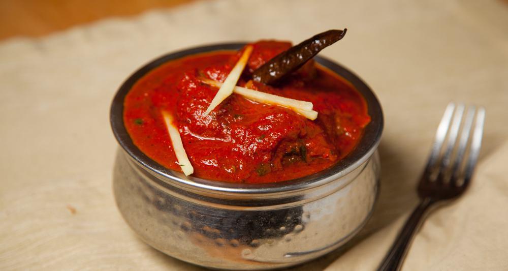 Lamb Vindaloo · Among the many Portuguese influence on Indian Cuisine, none is more popular than the vindaloo; a spice mix of garlic, vinegar, cumin seeds, cloves, cinnamon, Cochin peppercorns, Andhra chillies & turmeric.