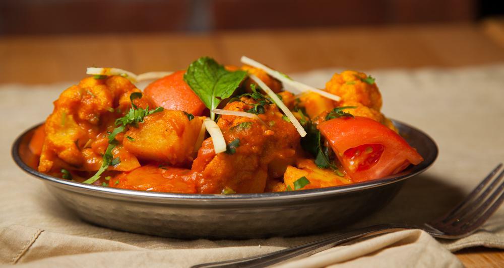 Aloo Gobhee Adrak Masala · Vegetarian, vegan, gluten free. Florets of cauliflower & potatoes tossed in a sauce of tomato, cumin, garlic, red chillies & ginger juliennes.