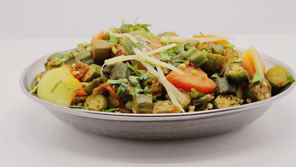 Bhendi Anardana · Vegetarian, vegan, gluten free. Fresh baby okra sauteed with onions, tomato, ginger, garlic, spices & crushed pomegranate seeds.