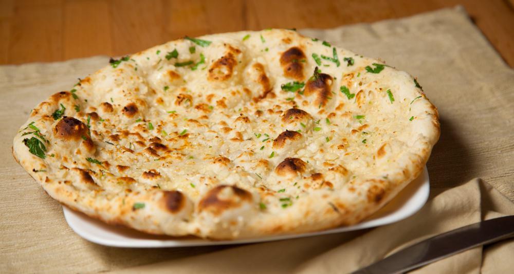Garlic Naan (Tandoor) · Leavened white flour bread with fresh garlic.