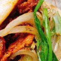 Pork Baos · Spicy marinated pork with cucumber and scallions in Bao buns.