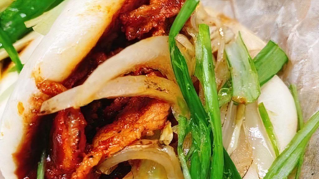 Pork Baos · Spicy marinated pork with cucumber and scallions in Bao buns.