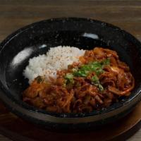 Spicy Pork Bap · Stir-fried spicy pork with rice serve on a sizzling hot stone plate
