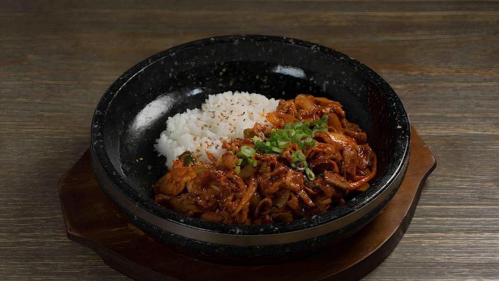 Spicy Pork Bap · Stir-fried spicy pork with rice serve on a sizzling hot stone plate