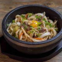 Bulgogi Udon · Stir-fried udon with marinated sliced beef and vegetable serve on a sizzling hot stone bowl