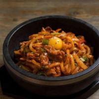 Spicy Pork Udon · Stir-fried udon with marinated pork and vegetable serve on a sizzling hot stone bowl