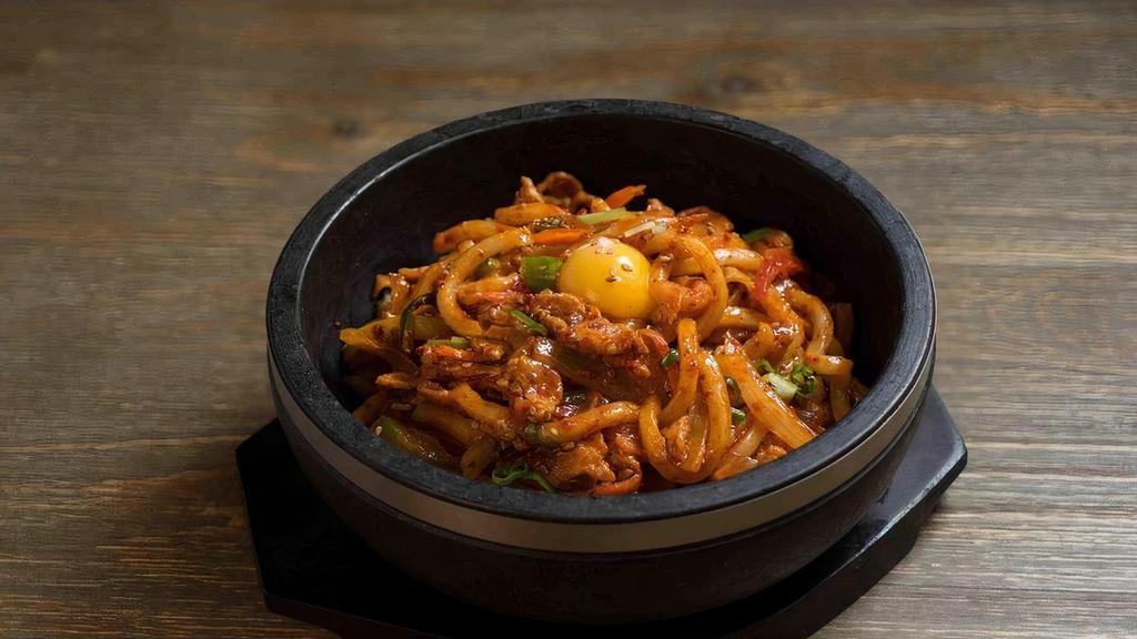 Spicy Pork Udon · Stir-fried udon with marinated pork and vegetable serve on a sizzling hot stone bowl