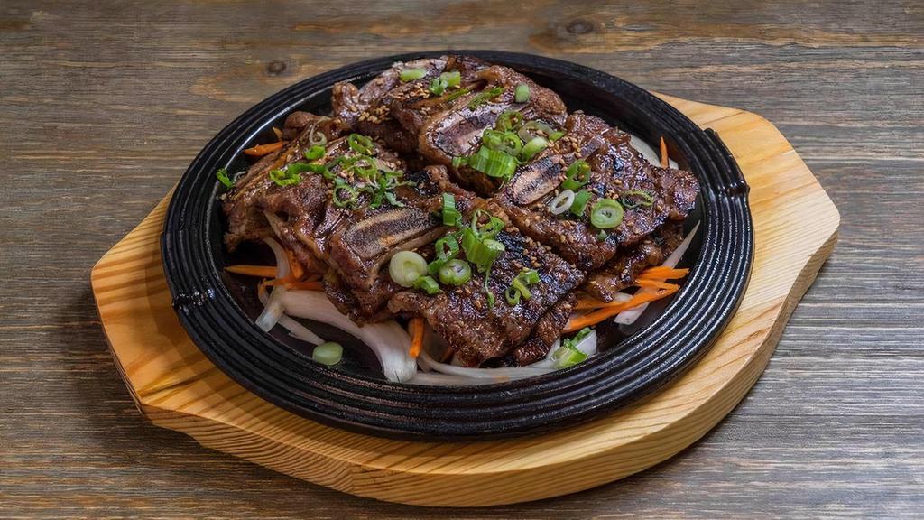 (Bbq) La Galbi · House-made traditional sweet soy, plum, ginger, pear, scallion.  and fresh citrus marinated prime cut beef short rib
