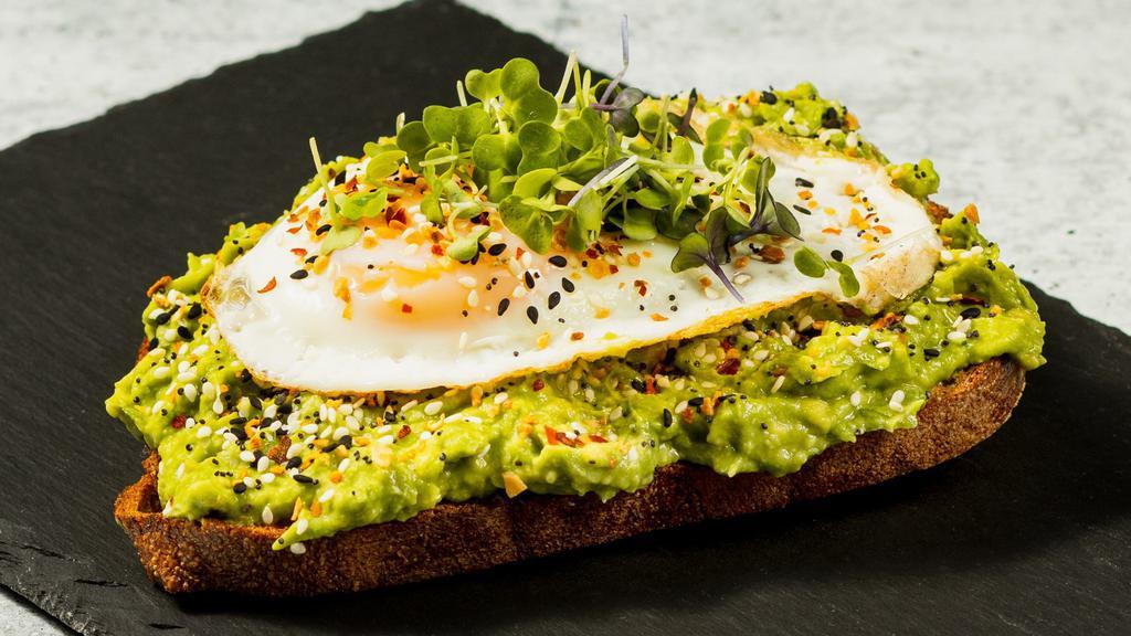 Ultimate Breakfast Avocado Toast · Ultimate Breakfast – fresh mashed avocado topped with everything bagel seasoning, crushed red pepper flakes, microgreens and fried egg on a toasted organic sourdough bread.