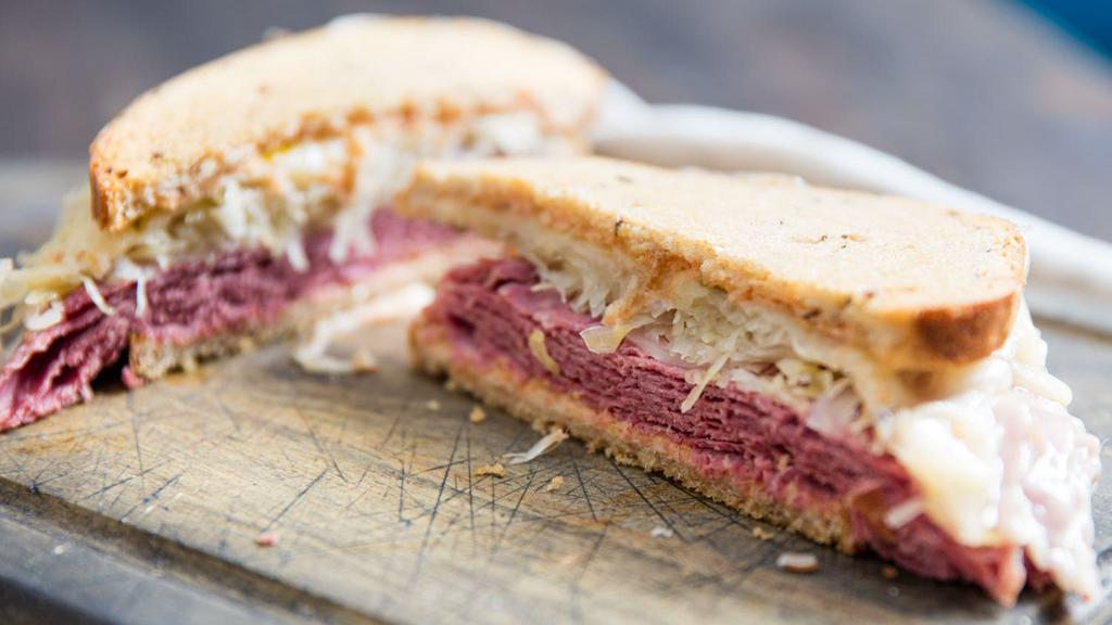 The Reuben · Hot pastrami or corned beef mixed with coleslaw, melted swiss cheese, and Russian dressing on toasted rye bread.