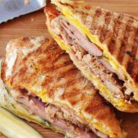 Cuban Sandwich · Grilled layers of ham, melted swiss cheese, sliced pickles, and honey mustard on toasted gar...