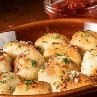 Garlic Knots · Freshly-baked dough topped with olive oil, fresh garlic, parsley & Pecorino Romano, served w...