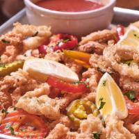 New England Style Calamari · Fried calamari, garnished with pickled hot cherry peppers & lemon. Served with house-made po...