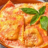 Baked Ravioli · Our home-style ravioli baked in a tomato cream sauce, topped with fresh basil & Pecorino Rom...