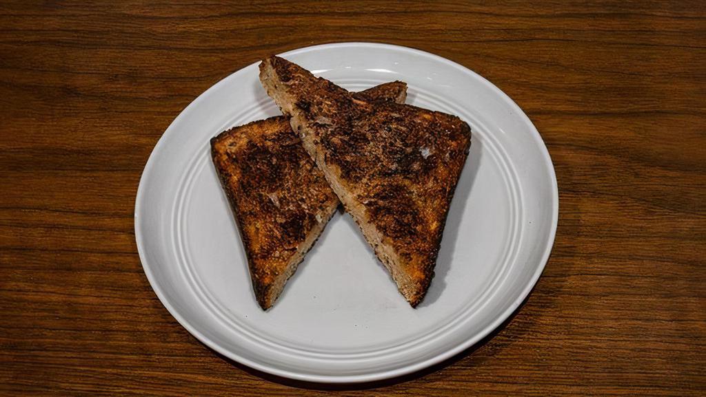 Convict · Vegemite & butter on thick cut multigrain toast.