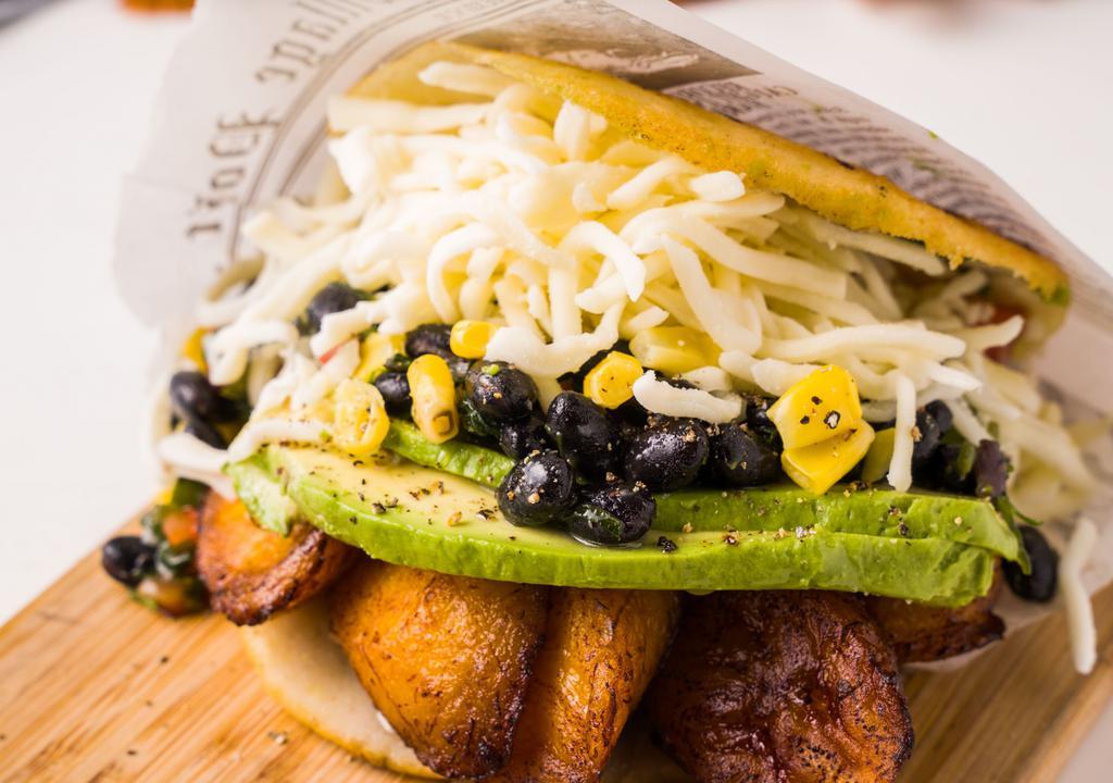 Arepa Pabellon Vegetariano · Arepas VIP favorite: Black beans, avocado, cheese, sweet plantain and corn. Add steak for an additional charge.