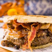 Arepa Burger · Burger pattie, bacon, mushrooms, caramelized onions and cheese.