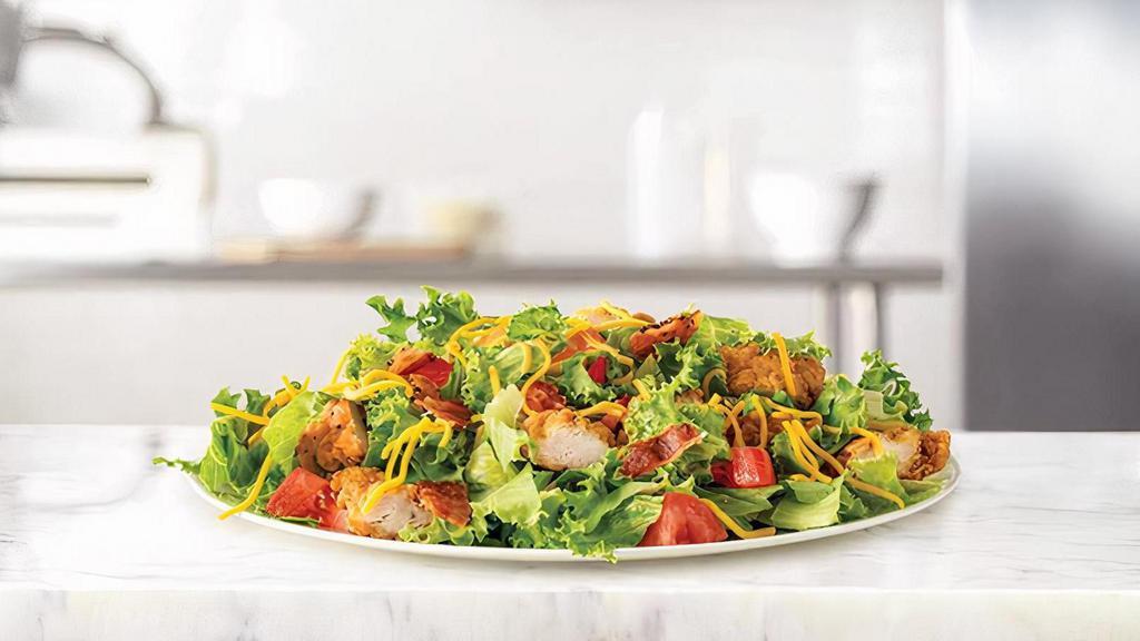 Crispy Chicken Salad · Crispy chicken and diced pepper bacon on a bed of chopped fresh lettuce with diced tomatoes and shredded cheddar cheese. Served with choice of dressing. Visit arbys.com for nutritional and allergen information.