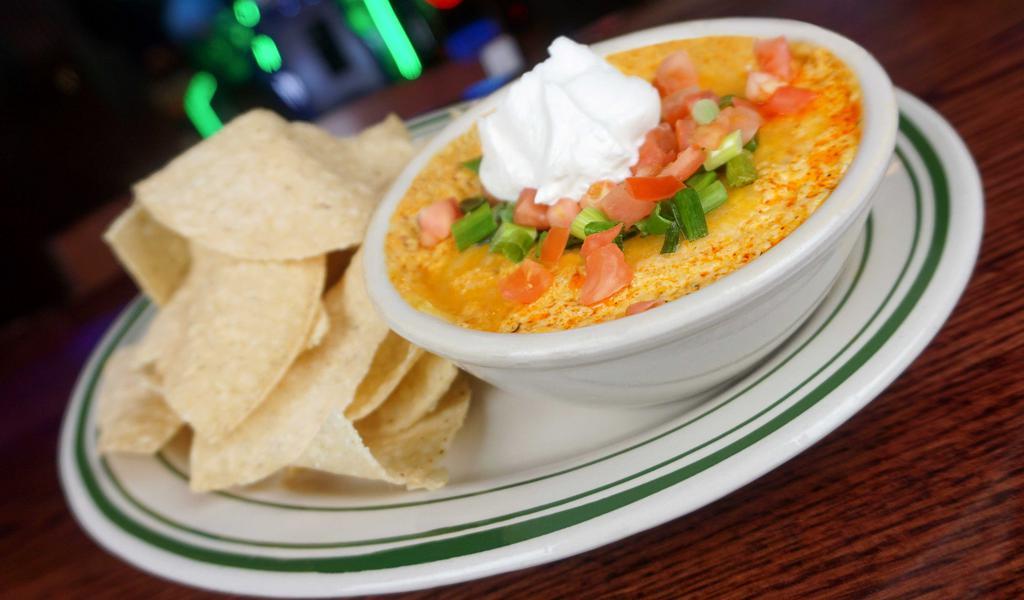 Chicken Wing Dip (Gs) · Our homemade spicy dip topped with melted jack- Our homemade spicy dip topped with melted Jack-cheddar cheese and sour cream. Served with tortilla chips.