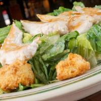 Grilled Chicken Caesar Salad · Crisp romaine tossed with Caesar dressing and homemade croutons, topped with grilled chicken.