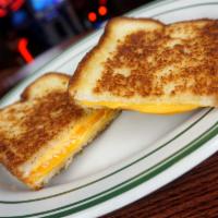 The Ultimate Grilled Cheese · Cheddar, yellow American and white American cheese on country white bread.