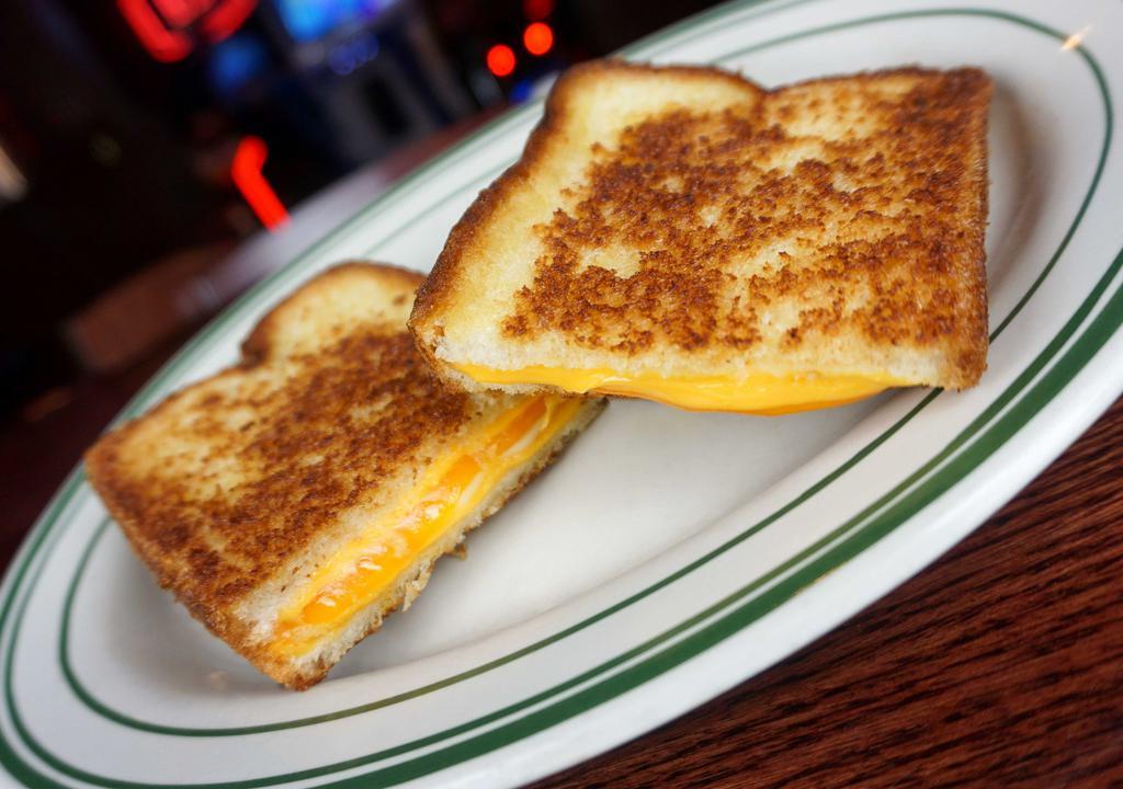 The Ultimate Grilled Cheese · Cheddar, yellow American and white American cheese on country white bread.