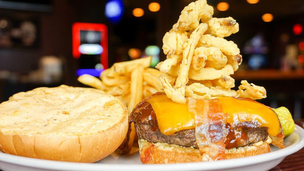 Smokehouse Burger · Bacon, cheddar cheese, BBQ sauce, sauteed red onion and Cajun mayo.