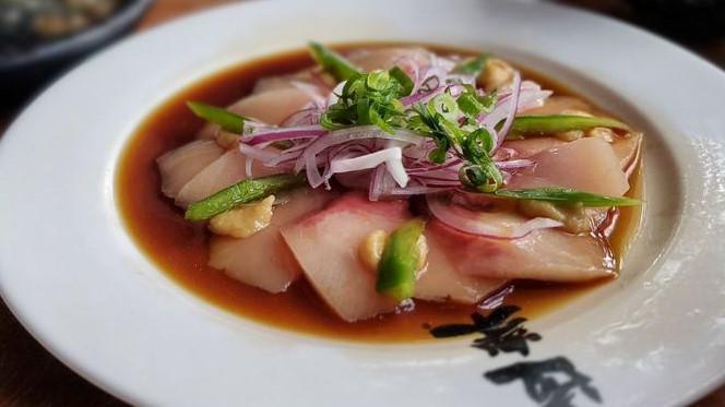 Hamachi Carpaccio · Thinly sliced hamachi sashimi garnished with jalapeño peppers, sweet miso, chili oil, red onions, green onions, and ponzu sauce.