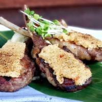 Rack Of Lamb · Marinated in garlic, rosemary, and thyme and lightly encrusted with panko and served over wa...