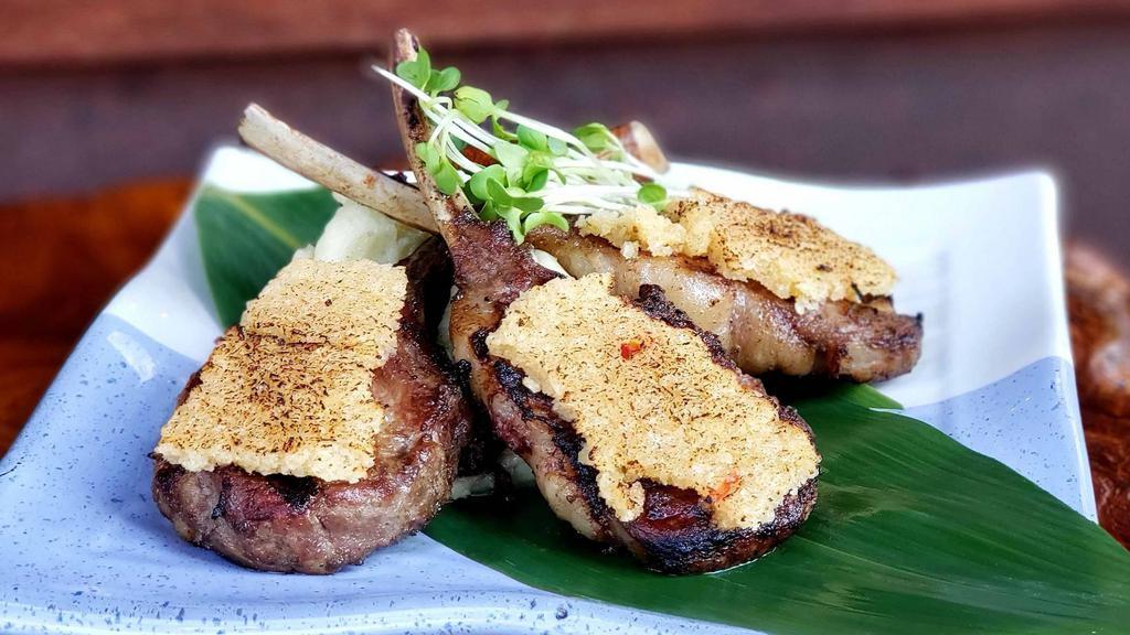 Rack Of Lamb · Marinated in garlic, rosemary, and thyme and lightly encrusted with panko and served over wasabi smashed potatoes.