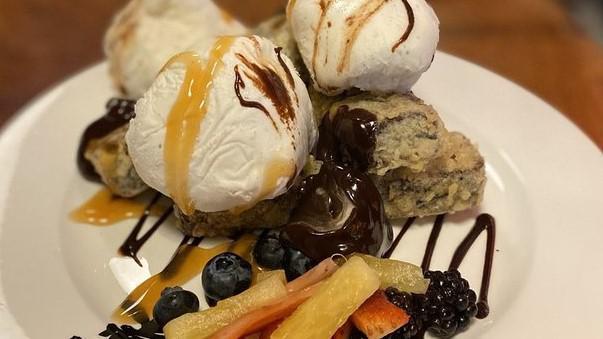 Brownie Tempura · Homemade brownie tempura topped with fresh chopped fruits, chocolate, and macadamia nuts served with tahitian vanilla ice cream.