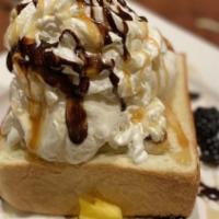 Classic Honey Toast · Stacked with flambe banana, strawberries, and vanilla ice cream with honey.