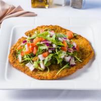 Vitello Milanese · Breaded veal cutlet pen fried topped with chopped tomatoes, onions, and arugula.