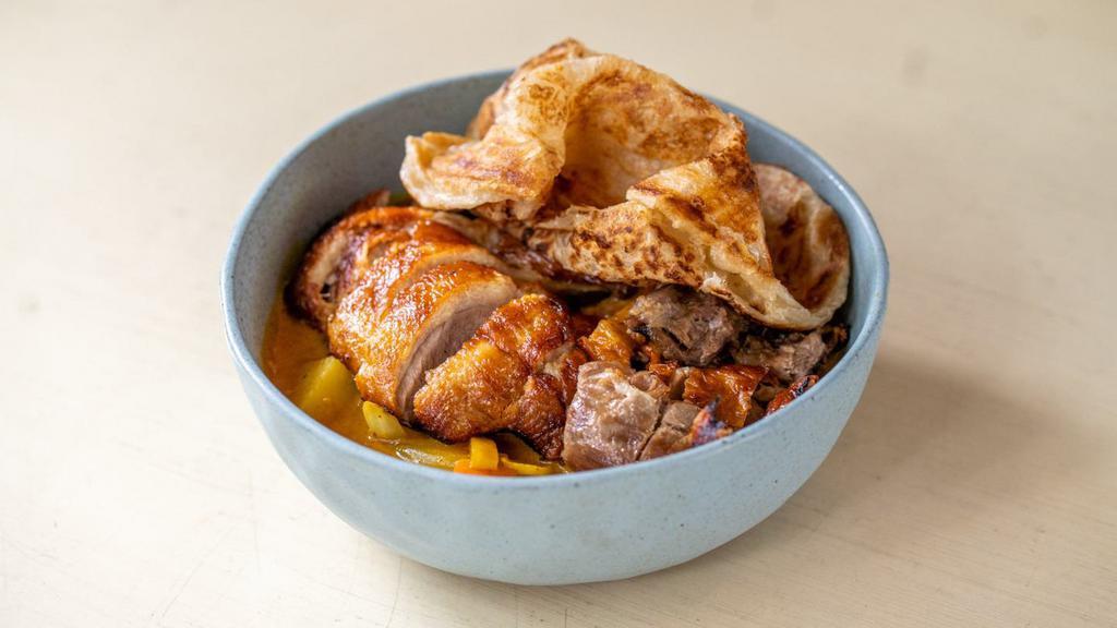 Pineapple Duck Curry · Spicy. A half duck simmered in a medium spicy curry enhanced with white onions, carrots, pineapples, and potatoes served with a side of plain roti.