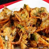 Vegetable Pakora Per Lb · 1lb  Fritters prepared with gram, flour, herbs, and spices.