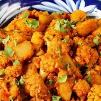 Alu Gobi Masala · Potatoes and cauliflower cooked with fresh tomatoes, onion, and spices.