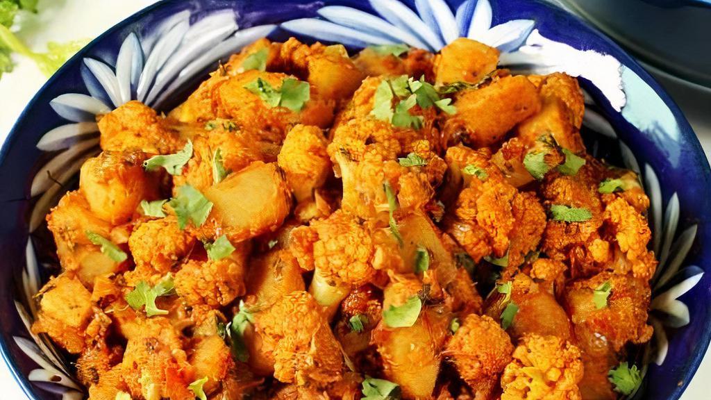 Alu Gobi Masala · Potatoes and cauliflower cooked with fresh tomatoes, onion, and spices.