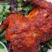 Chicken Tandoori Full · Whole chicken marinated with herbs and barbecued in a clay oven.