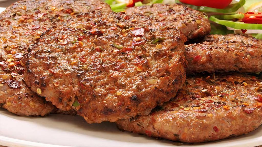 Chicken Chapli Kabab · Grilled ground chicken patty mixed with spices and chopped onion.
