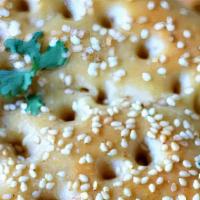 Sesame Naan · Soft flour bread sprinkled with sesame seeds and baked fresh in clay oven.