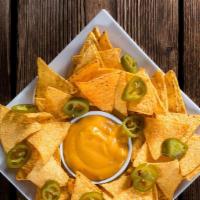 Nachos · Crunchy chips covered in melted cheese, sour cream, olives, and jalapeños.